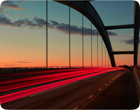 A bridge at sunset with light trails